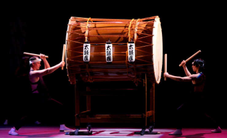 Taikoza drumming on a Japanese drum