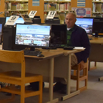 Man sitting at one of the library's computers