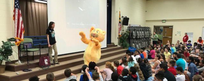 Outreach image showing an outreach event with kids and a mascot