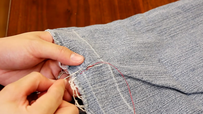 hand sewing repair of jeans