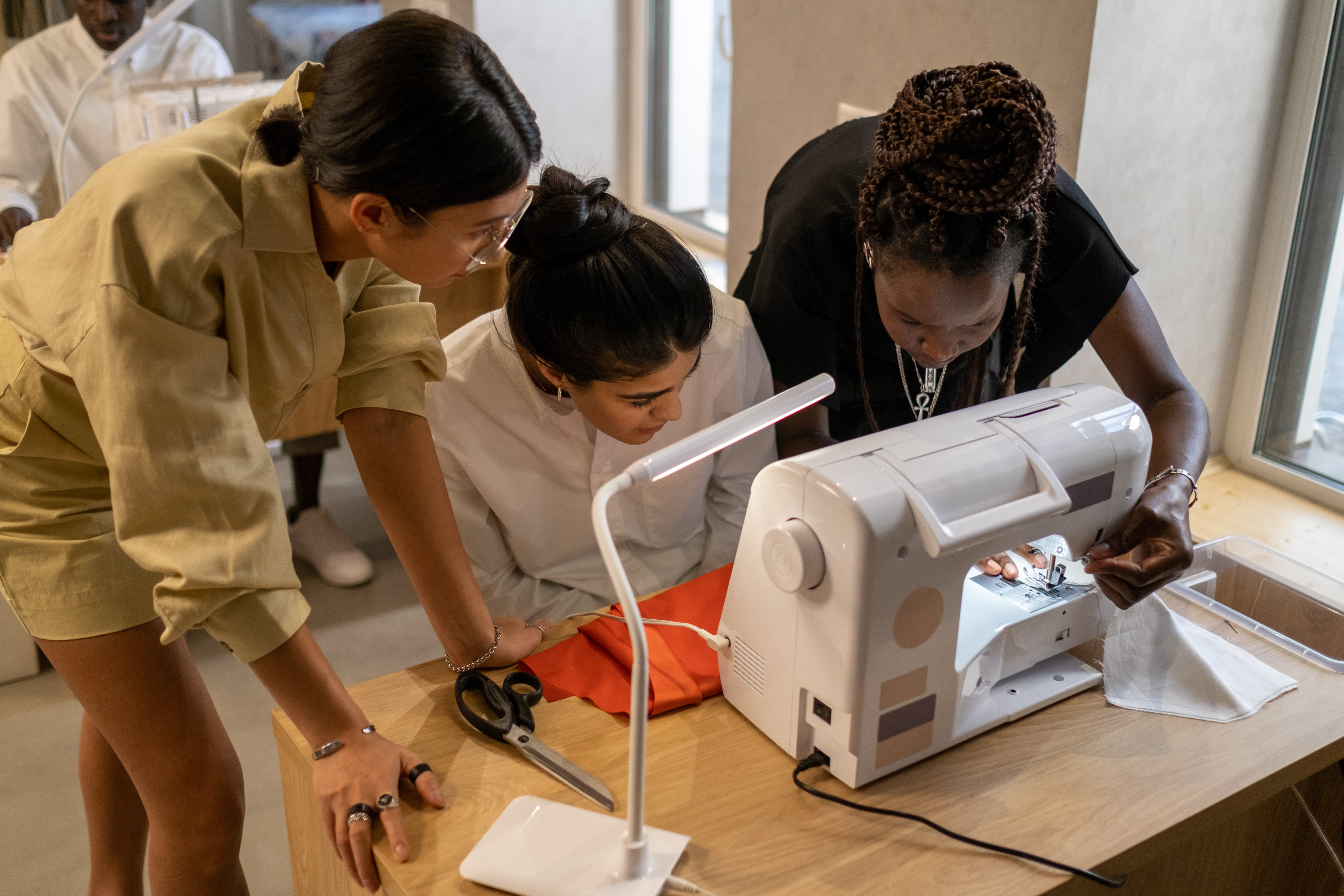 3 diverse women using sewing machine