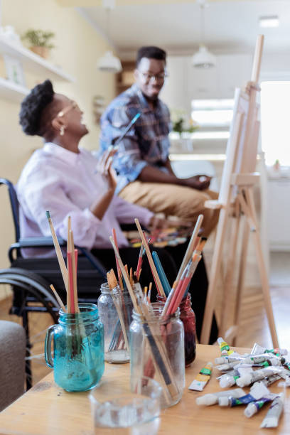 person at a an easel in wheelchair
