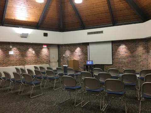 Eastport-Annapolis Community Meeting Room with chairs arranged auditorium-style with projection screen at front of room