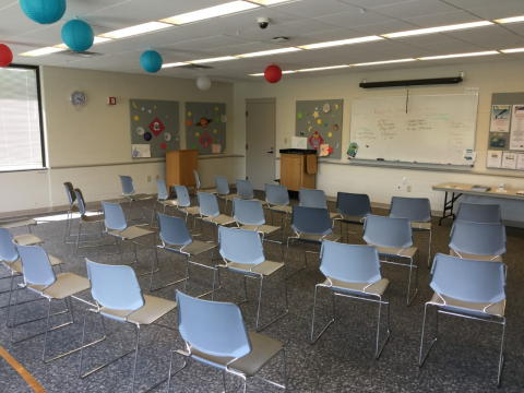 Deale Community Meeting Room with chairs arranged auditorium style with whiteboard at front of room