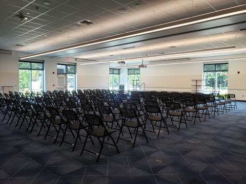 Large meeting room with many chairs set up theater-style