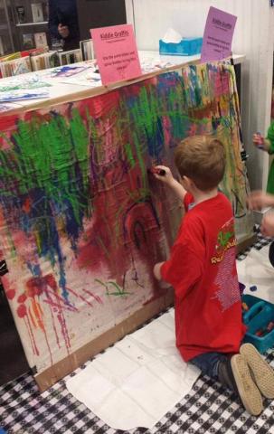 child painting on canvas