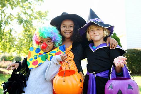 A group of children wearing Halloween costumes