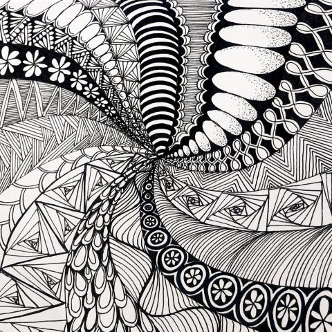 Swirling design with numerous Zentangle patterns.