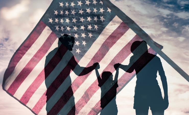 Silhouette of family in front of American flag